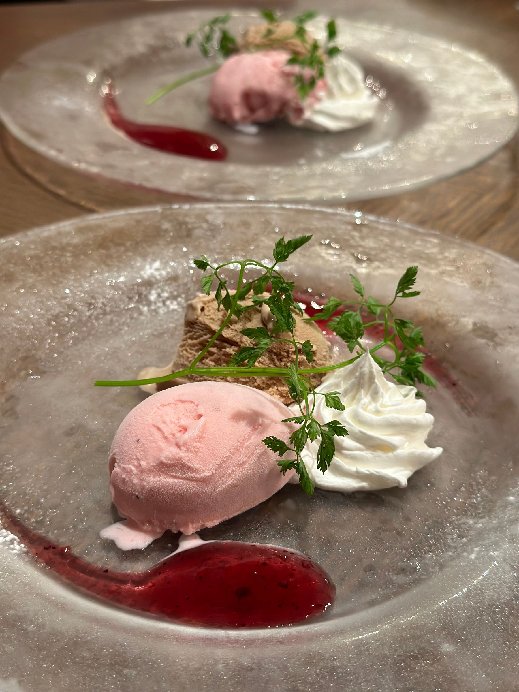 Fine dining dessert plated with cream and herbs