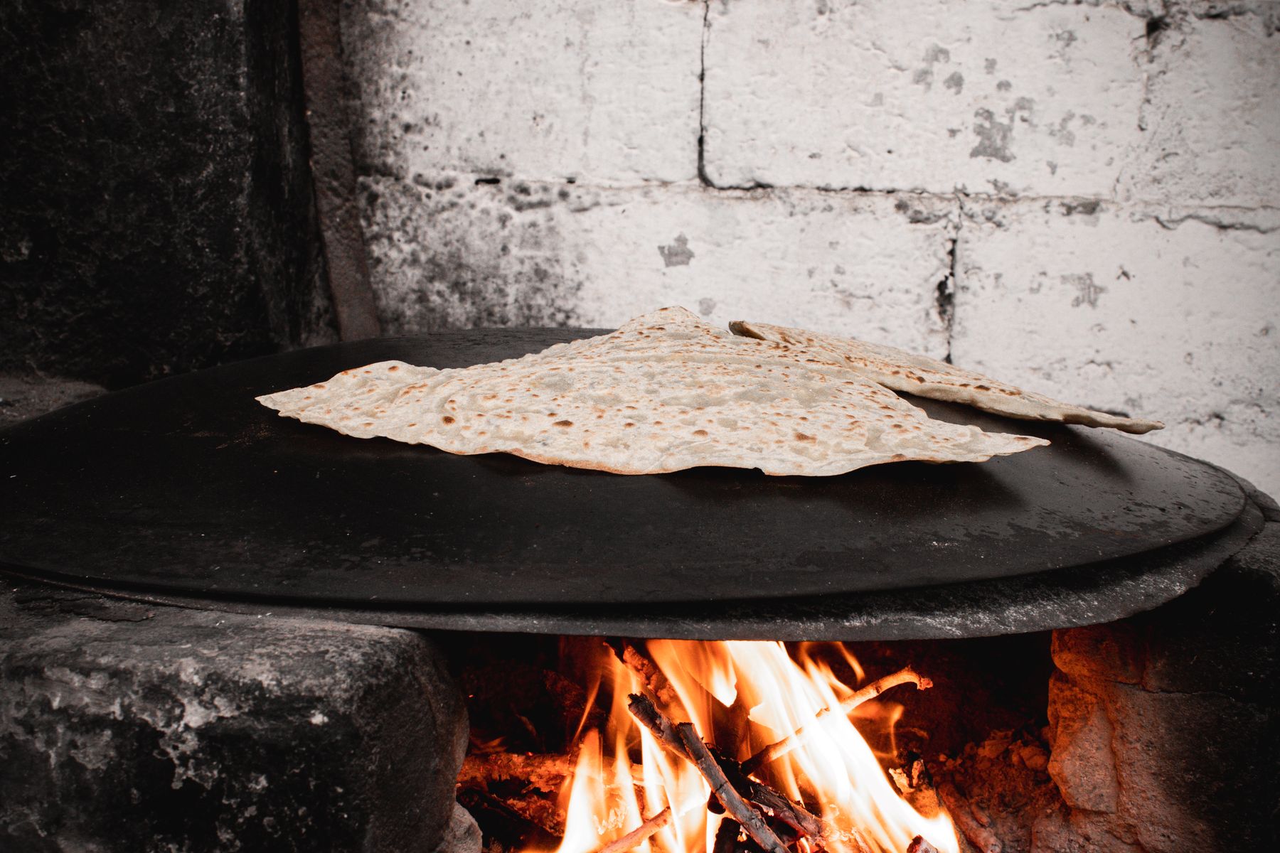 Flatbread cooking over wood fire